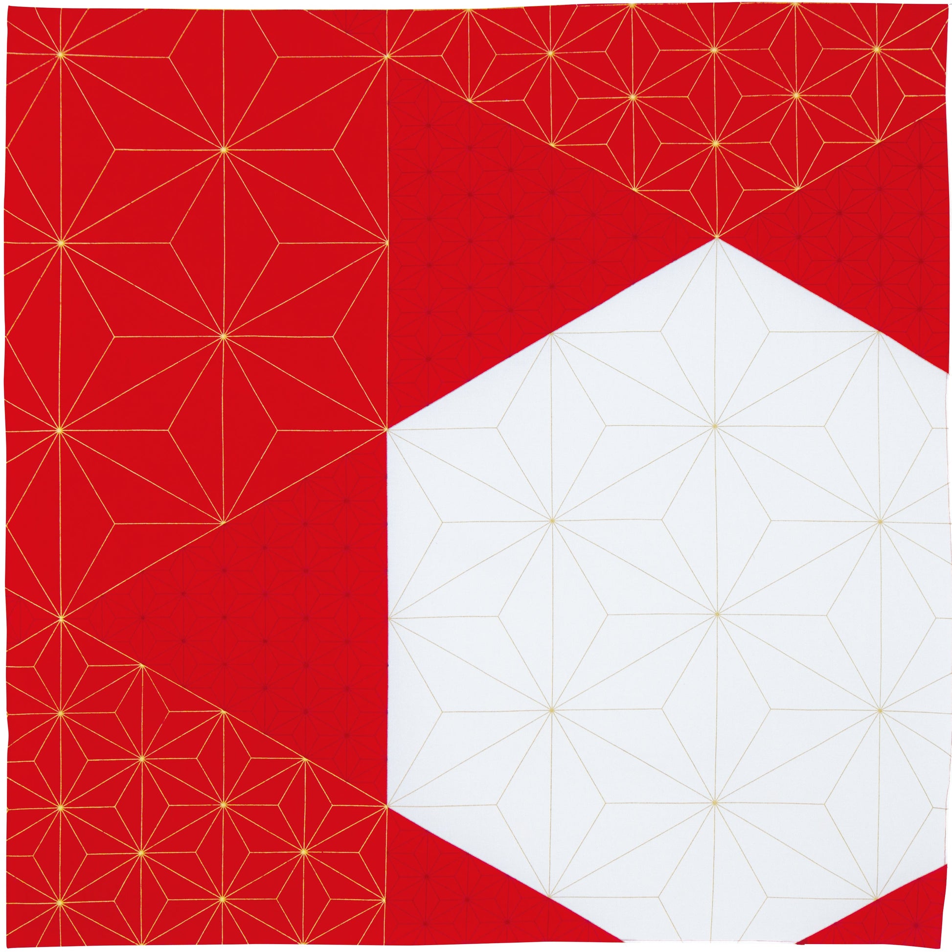 Flat lay top-down view of a square Japanese furoshiki fabric wrap with a bold red and white geometric asymmetric block design accented by gold star lines.