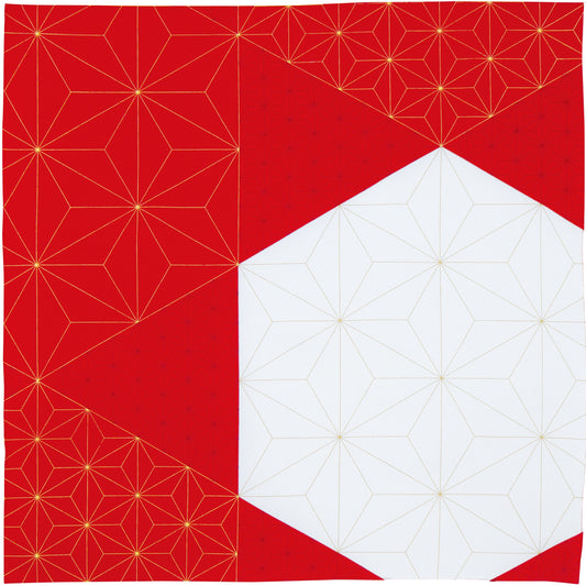 Flat lay top-down view of a square Japanese furoshiki fabric wrap with a bold red and white geometric asymmetric block design accented by gold star lines.