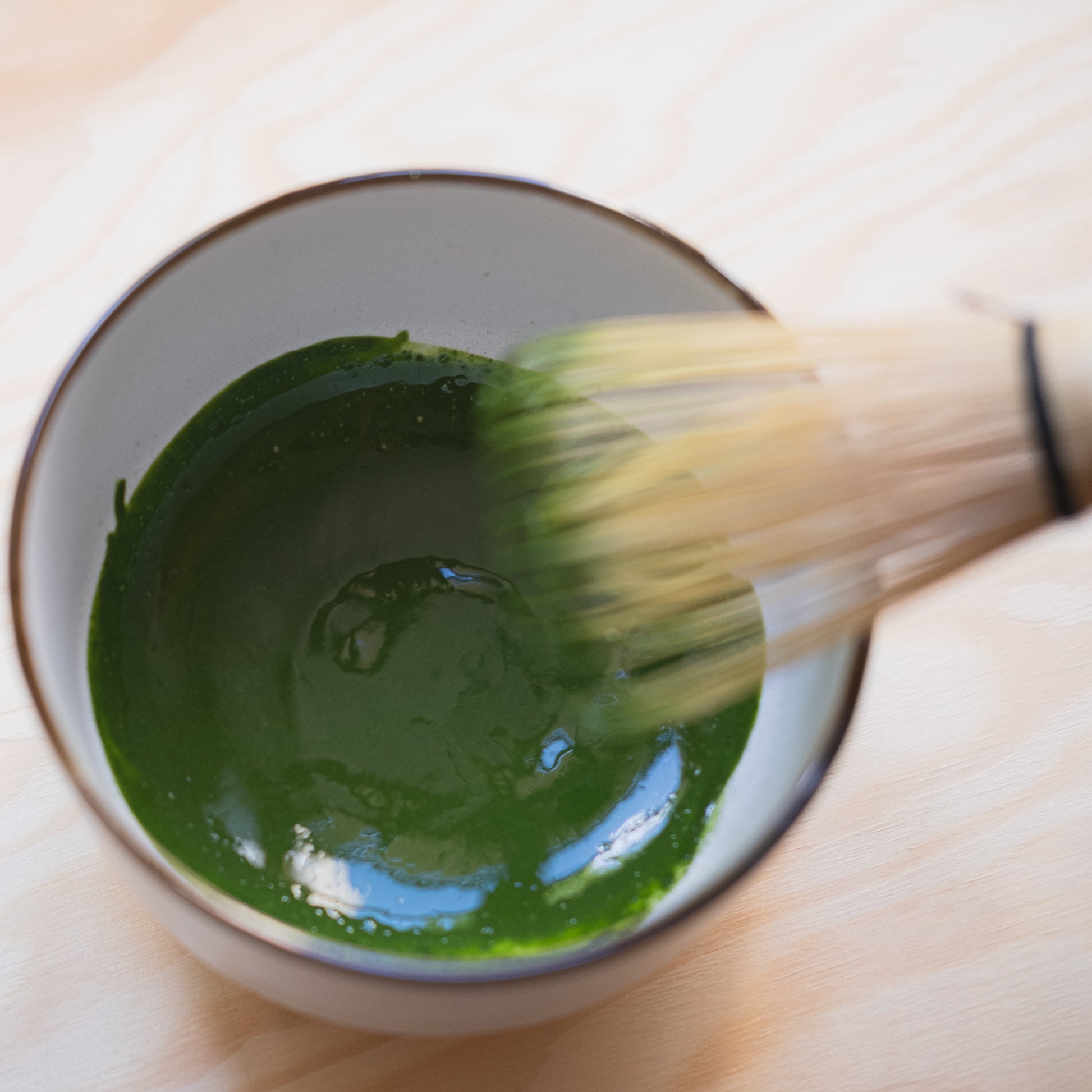 Freshly green matcha paste made with traditional Japan whisk 